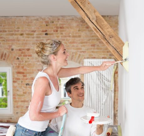 Woman with brush whitening next to man assisting her
