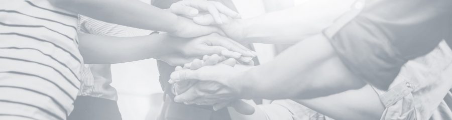 Close up view of young business people putting their hands together. Stack of hands. Unity and teamwork concept.