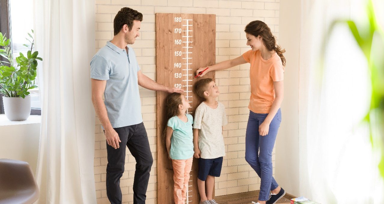 Parents measuring children's height