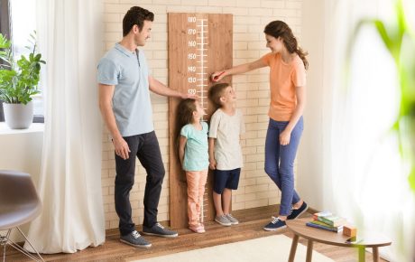 Parents measuring children's height